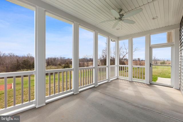 unfurnished sunroom with ceiling fan