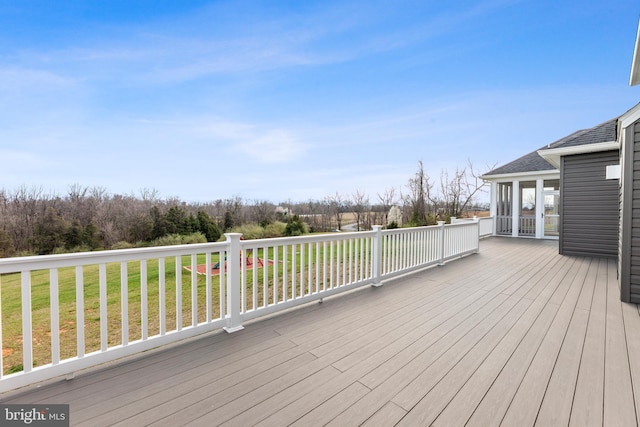 wooden terrace with a lawn