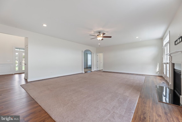 unfurnished living room featuring french doors, dark hardwood / wood-style floors, and ceiling fan