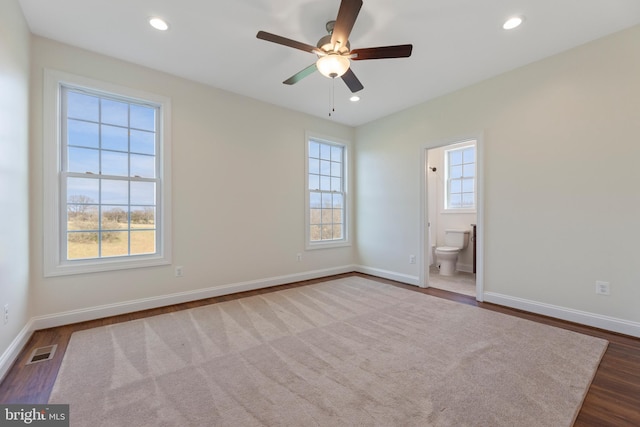 carpeted empty room with plenty of natural light and ceiling fan