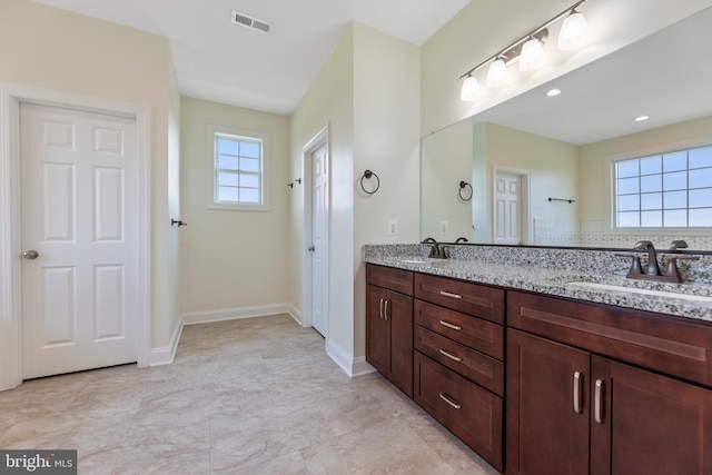 bathroom featuring double vanity and tile floors