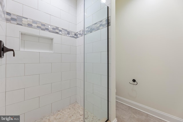 bathroom featuring tile floors and a shower with shower door