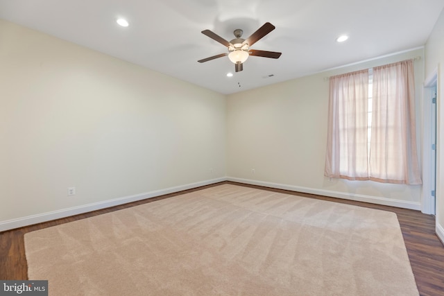 empty room featuring dark colored carpet and ceiling fan