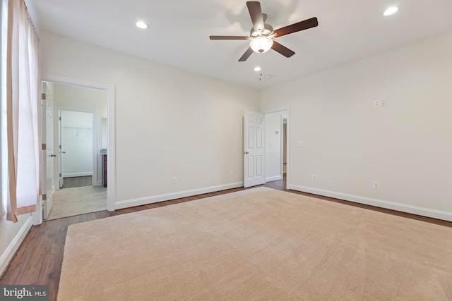 empty room featuring dark carpet and ceiling fan