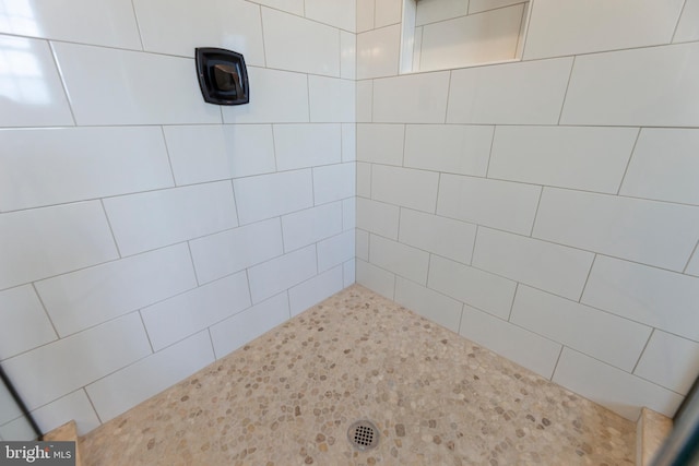 bathroom with a tile shower