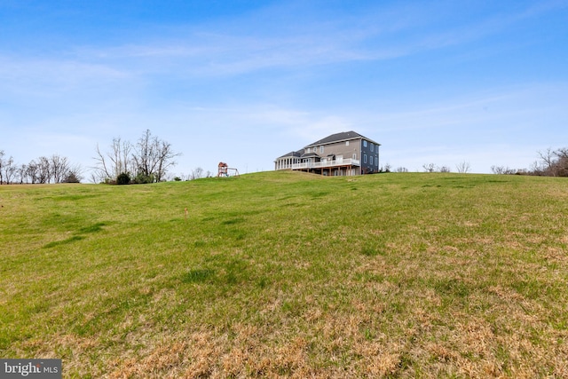 view of yard with a rural view and a wooden deck