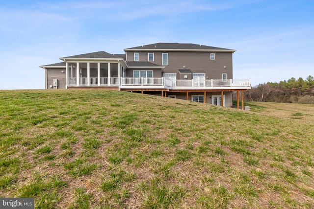 back of house with a yard and a sunroom