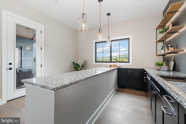 kitchen featuring light stone counters and light wood-style flooring