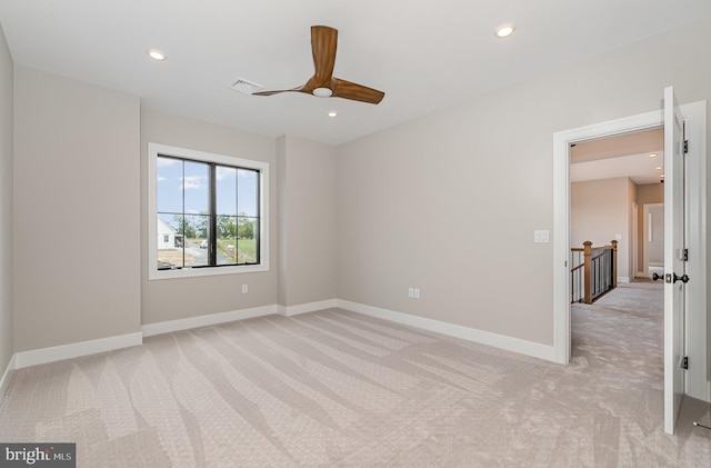 unfurnished room with a ceiling fan, visible vents, baseboards, recessed lighting, and light colored carpet