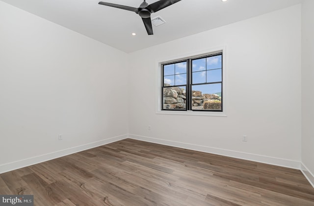 spare room with visible vents, wood finished floors, recessed lighting, baseboards, and ceiling fan