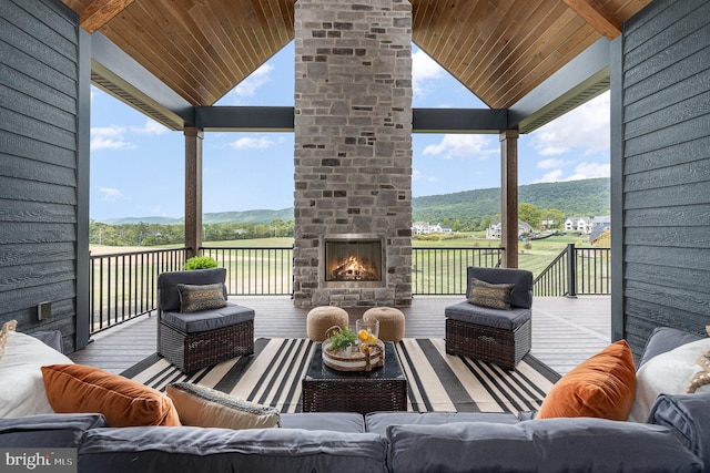 exterior space with an outdoor living space with a fireplace