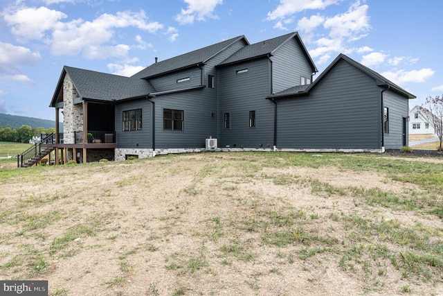 rear view of property featuring roof with shingles