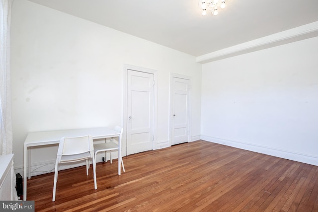 unfurnished office featuring hardwood / wood-style floors