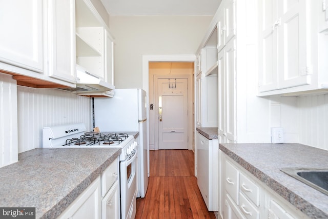 kitchen with white cabinetry, range with two ovens, and dark hardwood / wood-style floors