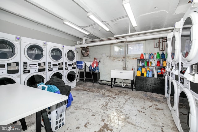 laundry room with stacked washing maching and dryer, sink, and separate washer and dryer