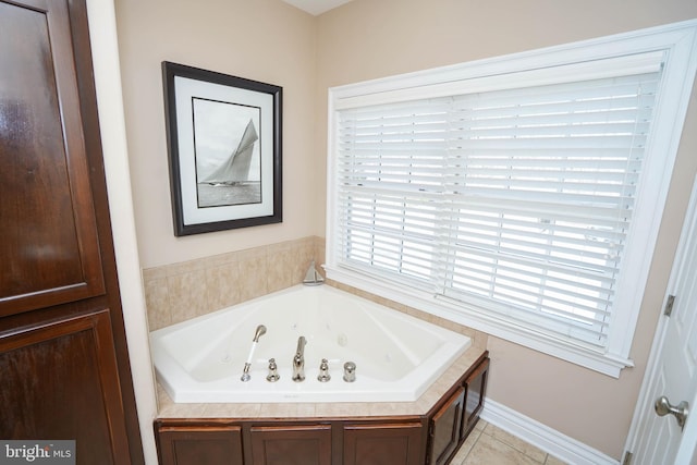 bathroom with a tub and tile patterned floors