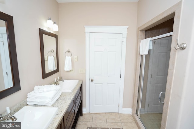 bathroom featuring vanity, tile patterned flooring, and a shower with shower door