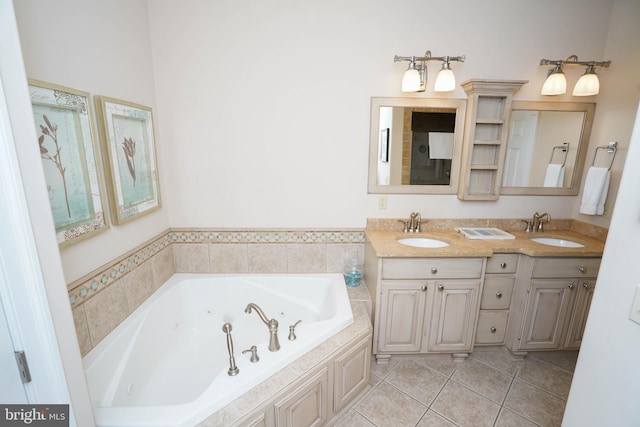 bathroom with a tub to relax in, vanity, and tile patterned floors