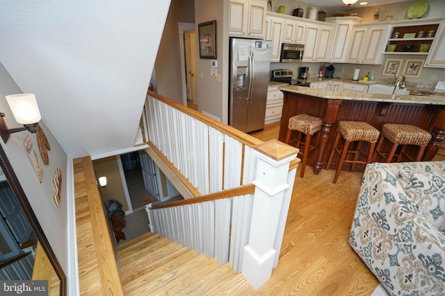 staircase with hardwood / wood-style flooring