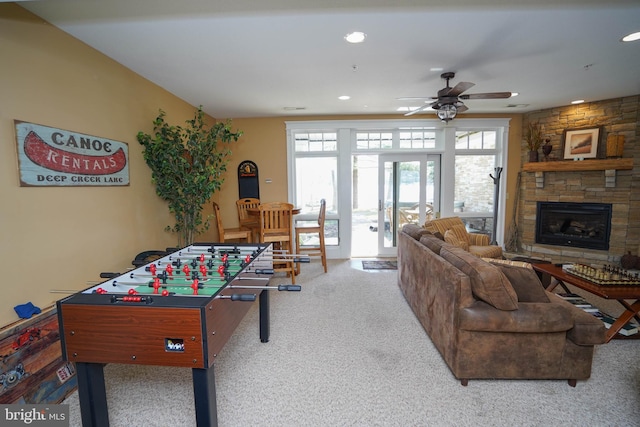 recreation room with french doors, carpet, ceiling fan, and a fireplace