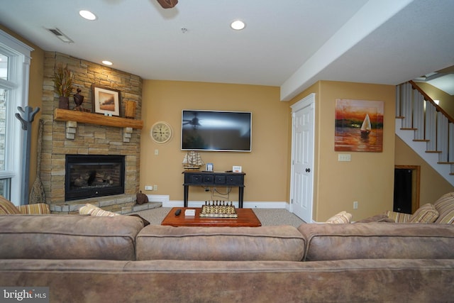 carpeted living room with a fireplace