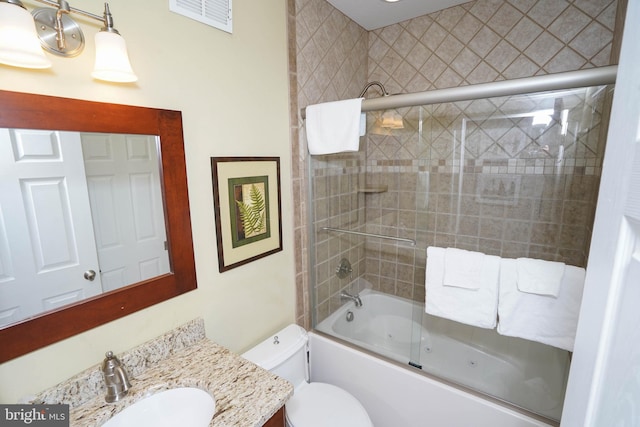 full bathroom with vanity, combined bath / shower with glass door, and toilet