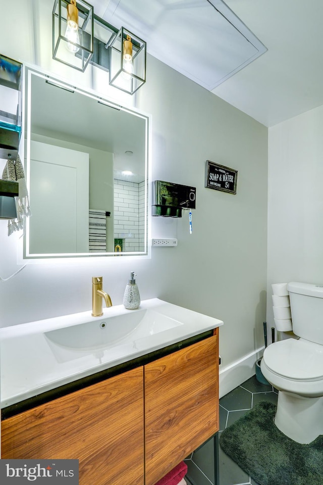 bathroom featuring toilet, tile flooring, and vanity