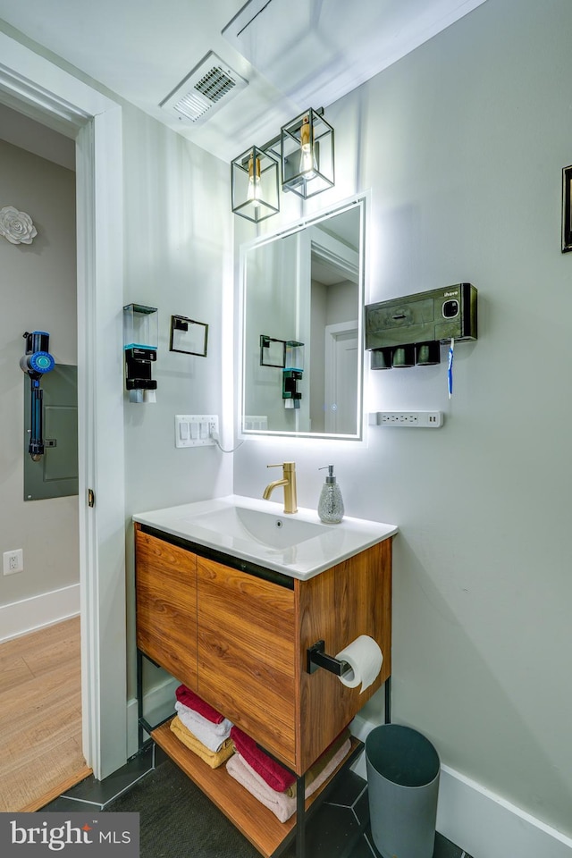 bathroom with hardwood / wood-style floors and vanity