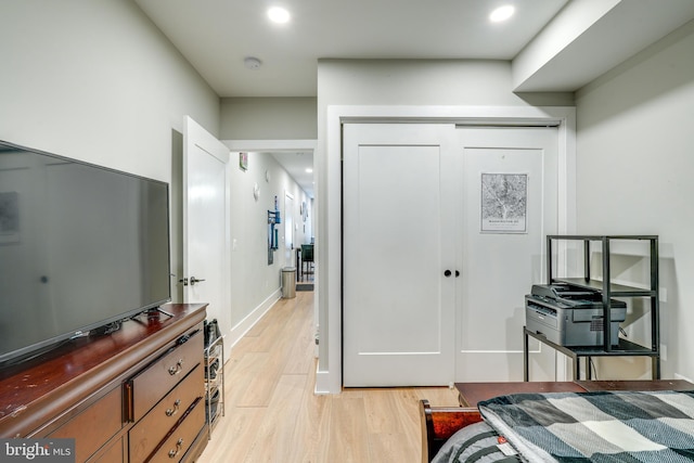 bedroom featuring a closet and light wood-type flooring