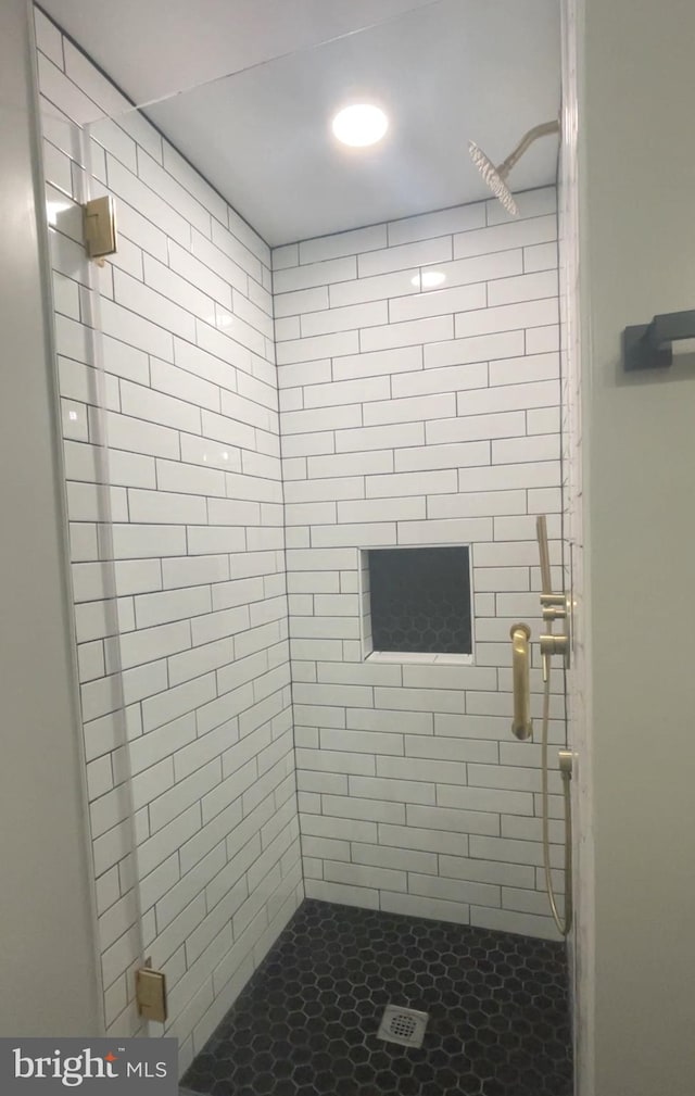 bathroom with tiled shower