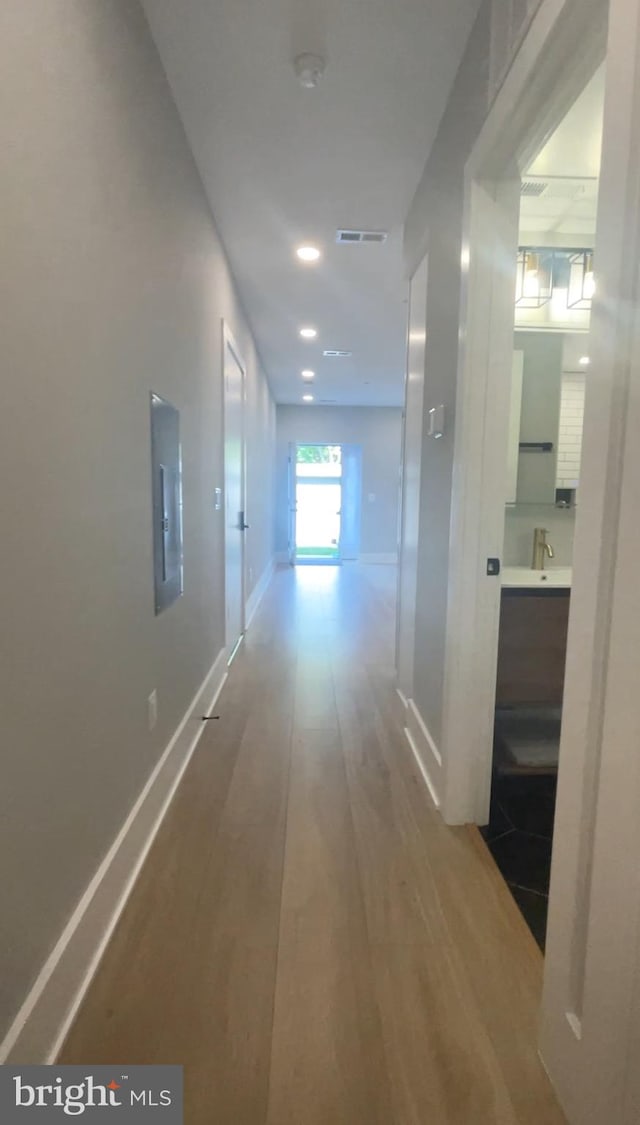 corridor with wood-type flooring