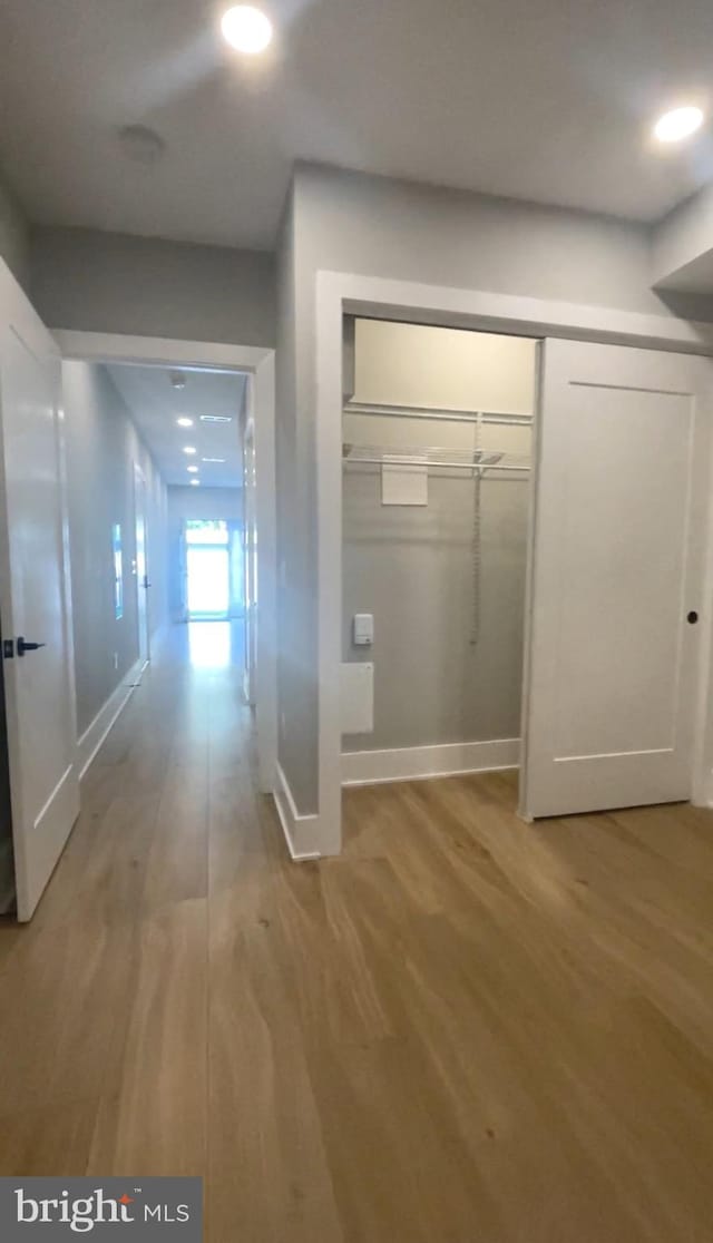 hallway with light wood-type flooring