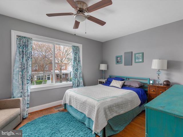 bedroom with ceiling fan and light hardwood / wood-style floors