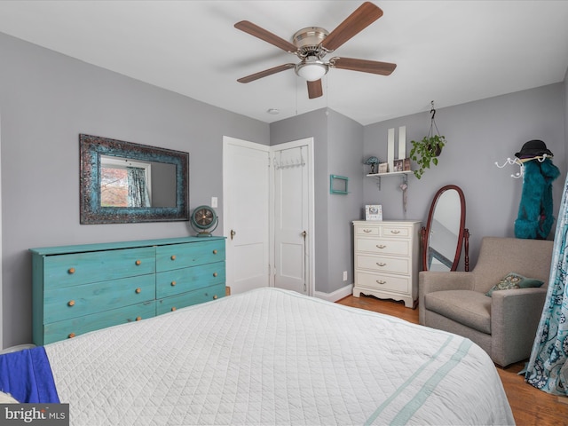 bedroom with ceiling fan and light hardwood / wood-style flooring