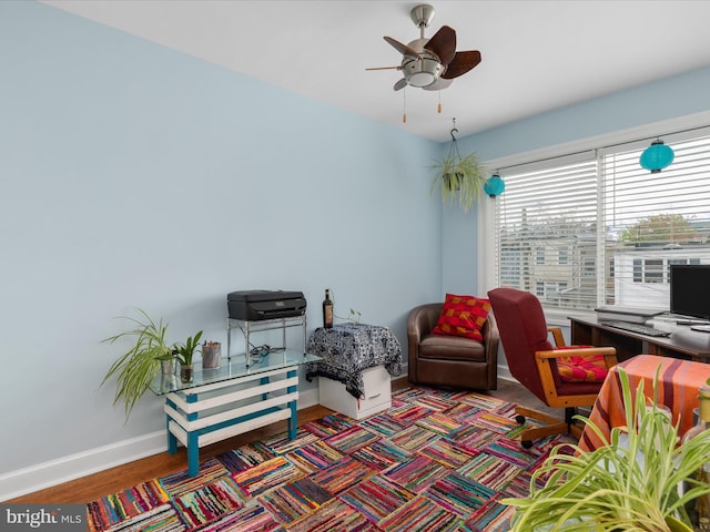 living room with ceiling fan and dark wood-type flooring