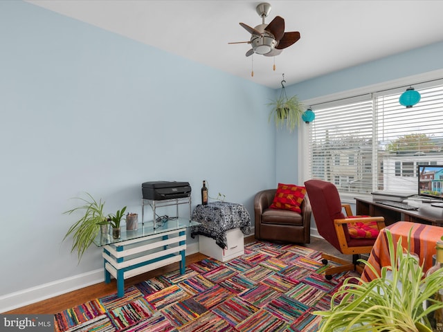 living room featuring ceiling fan and dark wood-type flooring