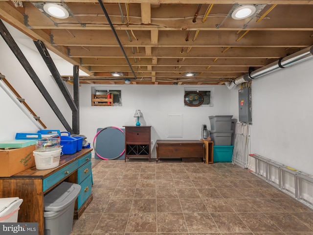 basement with dark tile flooring