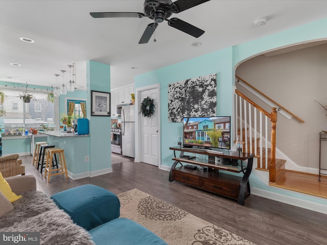 living room with ceiling fan and dark hardwood / wood-style floors