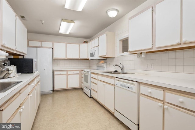 kitchen featuring backsplash, white appliances, white cabinetry, and sink