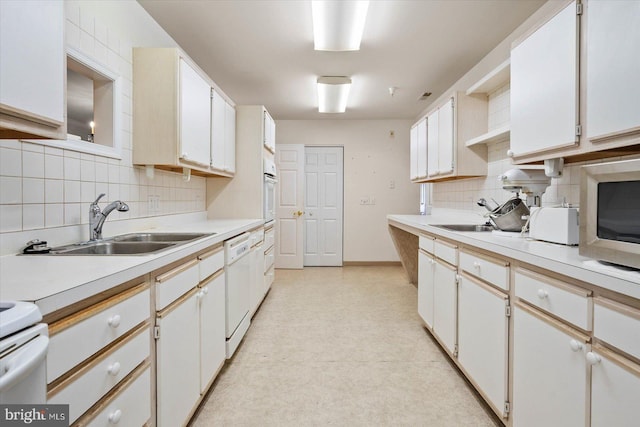 kitchen with backsplash and white cabinetry