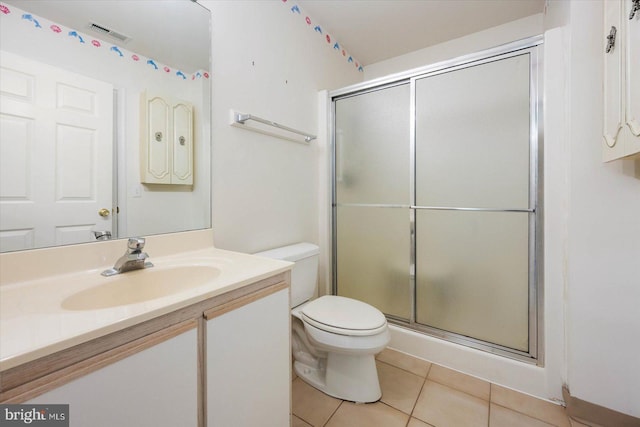 bathroom with a shower with shower door, tile flooring, toilet, and vanity