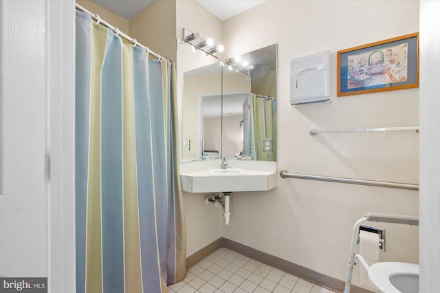 bathroom featuring tile floors and toilet