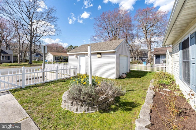 view of yard featuring an outdoor structure and a garage