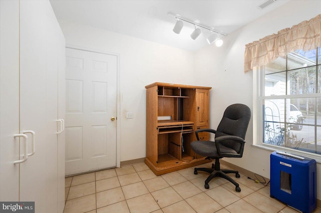 office with track lighting and light tile flooring