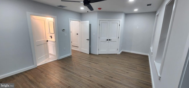 unfurnished bedroom with ceiling fan and dark hardwood / wood-style floors