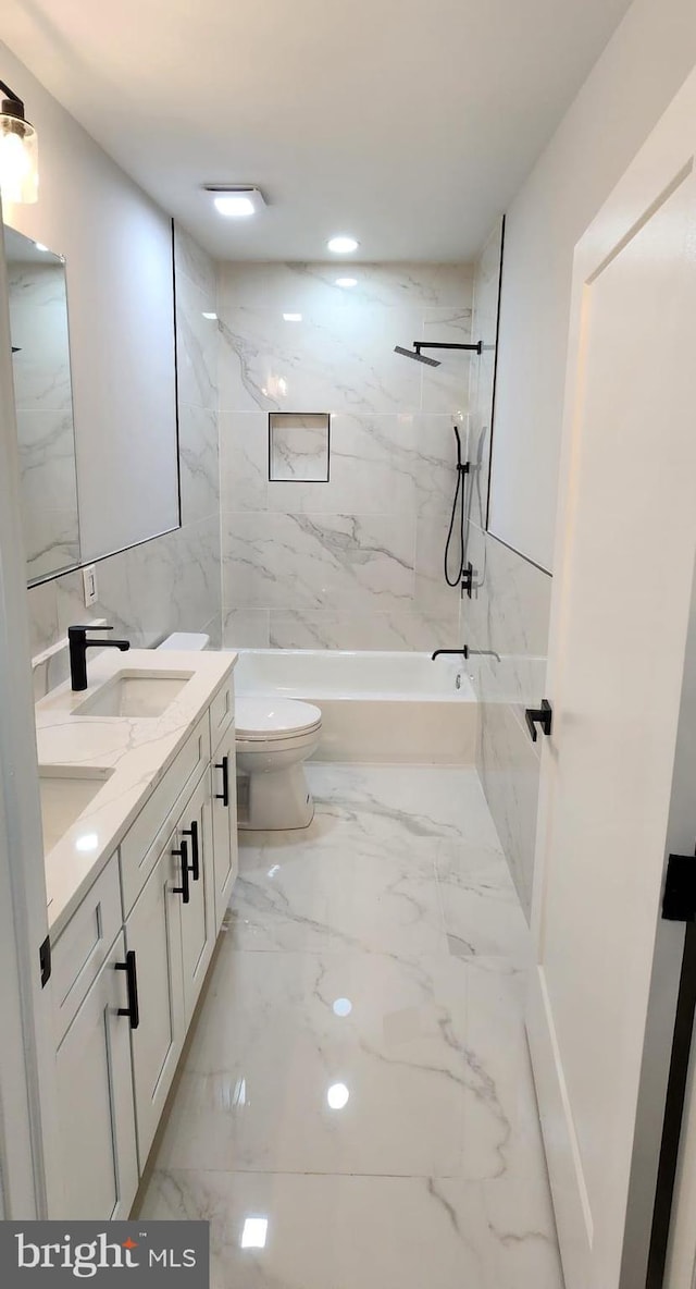 full bathroom with vanity, toilet, and tiled shower / bath combo