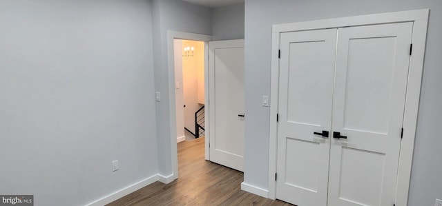 corridor with wood-type flooring