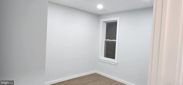 spare room with hardwood / wood-style floors