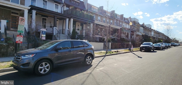 view of vehicle parking with a residential view