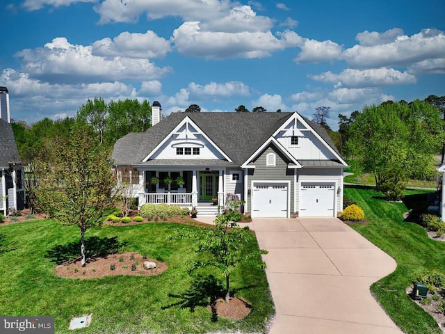 craftsman inspired home with covered porch, a garage, and a front lawn